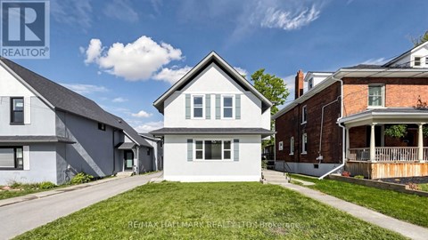 A house with a lawn in front is for sale.