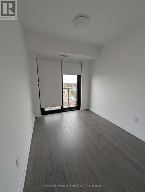 A room with a sliding glass door leading to a balcony.