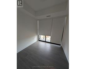 A room with a sliding glass door leading to a balcony.