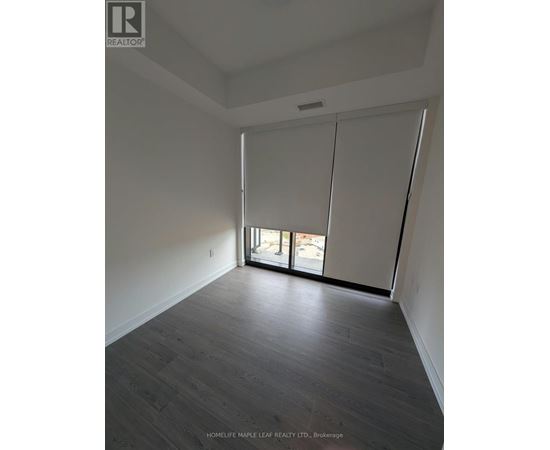 A room with a sliding glass door leading to a balcony.
