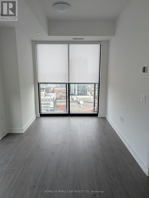 A room with a view of the city through large windows.
