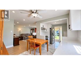 A modern kitchen with a dining table and chairs.
