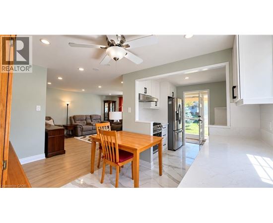 A modern kitchen with a dining table and chairs.