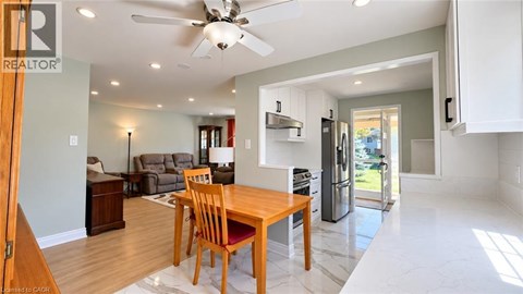 A modern kitchen with a dining table and chairs.