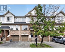 A large, two-story house with a garage is for sale.