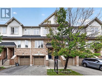 A large, two-story house with a garage is for sale.