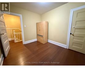 A room with a wooden floor and a white door.