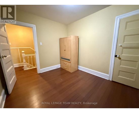 A room with a wooden floor and a white door.