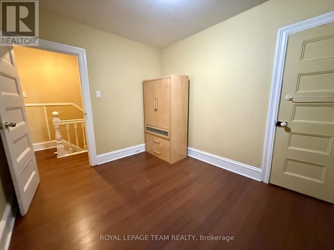 A room with a wooden floor and a white door.