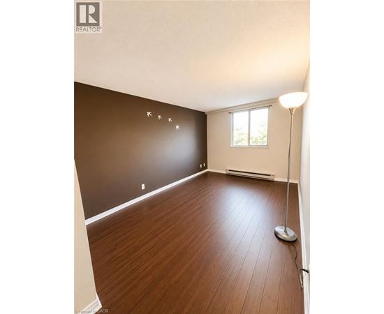 A room with wooden flooring and a window.