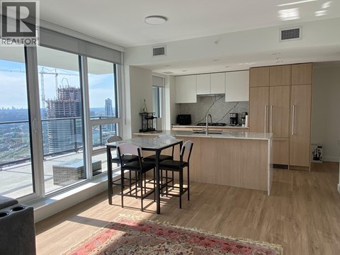 A modern kitchen with a dining table and chairs.
