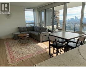 A living room with a view of the city skyline.