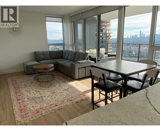 A living room with a view of the city skyline.