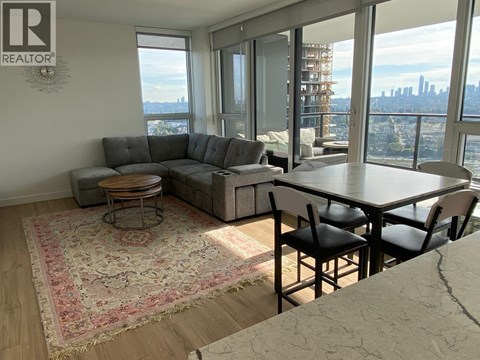 A living room with a view of the city skyline.