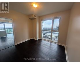 A room with a sliding glass door leading to a balcony.