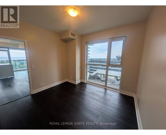 A room with a sliding glass door leading to a balcony.