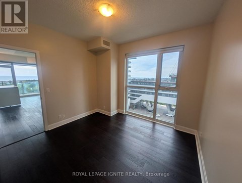 A room with a sliding glass door leading to a balcony.