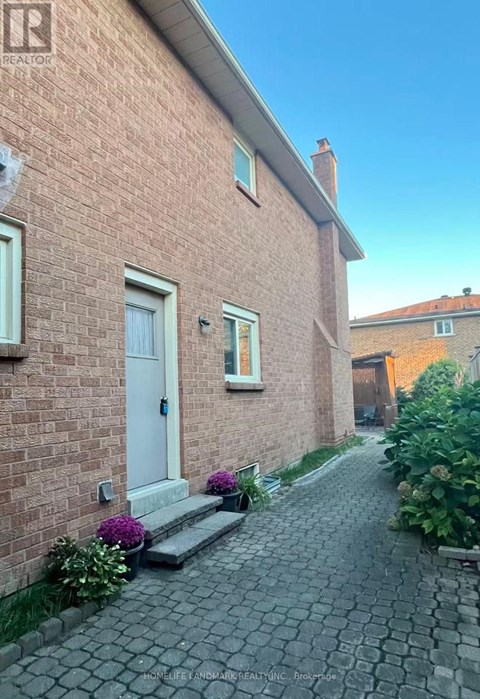 A brick house with a white door and windows.