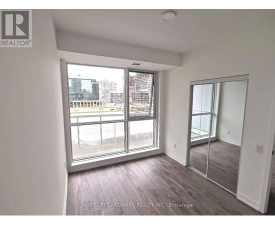 A room with a view of a cityscape through large windows.