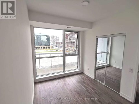 A room with a view of a cityscape through large windows.