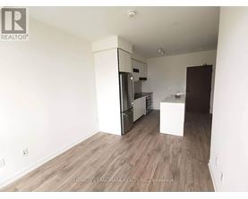 A kitchen area with a refrigerator, oven, and microwave.