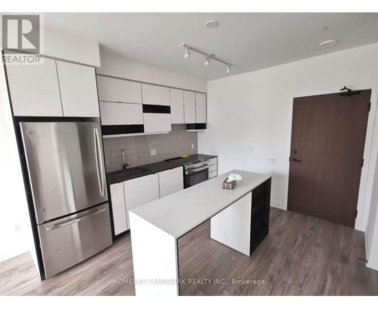 A modern kitchen with stainless steel appliances and white cabinetry.