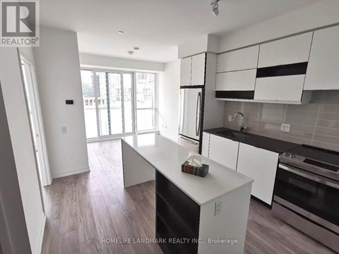 A kitchen with white cabinets and a black dishwasher.