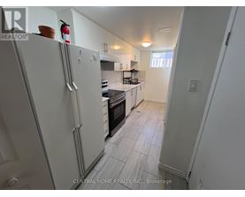A kitchen with white appliances and a white refrigerator.
