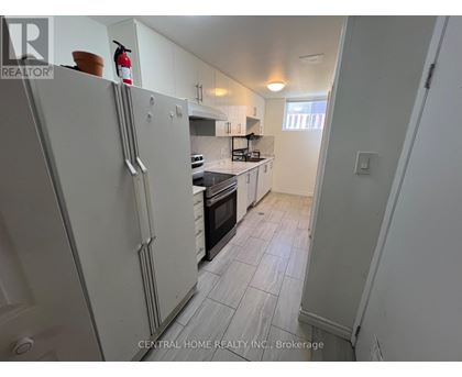 A kitchen with white appliances and a white refrigerator.