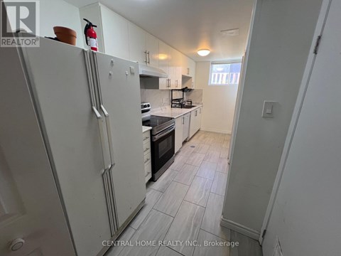 A kitchen with white appliances and a white refrigerator.