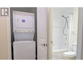 A white toilet with a tank and a shower with a white curtain.