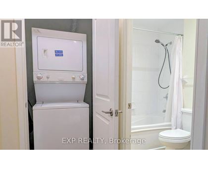 A white toilet with a tank and a shower with a white curtain.