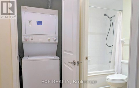 A white toilet with a tank and a shower with a white curtain.