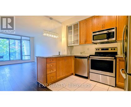 A kitchen with wooden cabinets and stainless steel appliances.