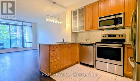 A kitchen with wooden cabinets and stainless steel appliances.