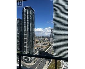A cityscape with a clear blue sky and two prominent buildings in the foreground.