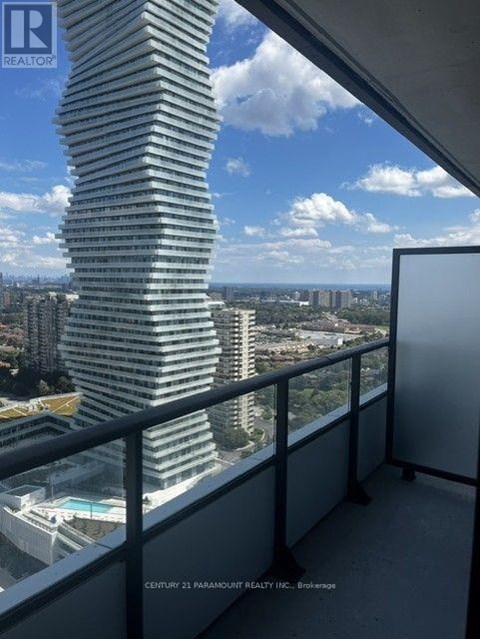 A tall, slender building with a curved facade dominates the skyline.