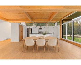 A dining room with a table and chairs.