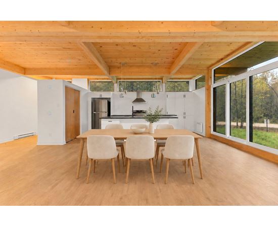 A dining room with a table and chairs.