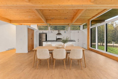 A dining room with a table and chairs.