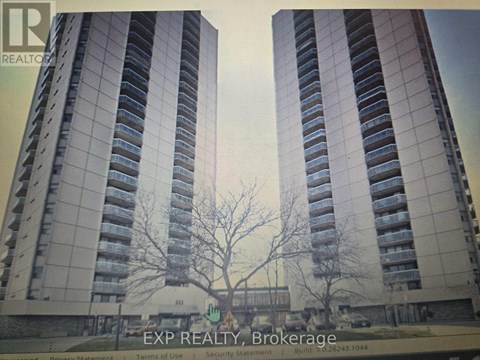 A tall building with a tree in front of it.