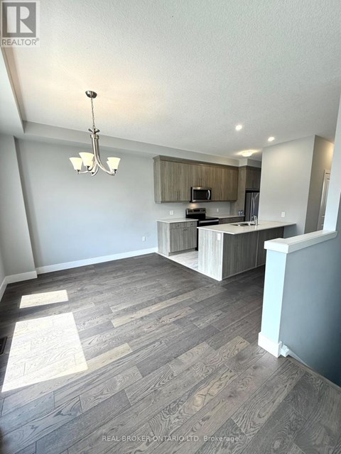 A well-lit kitchen with a dining area in a modern home.