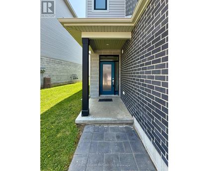 A house entrance with a blue door and a brick wall.