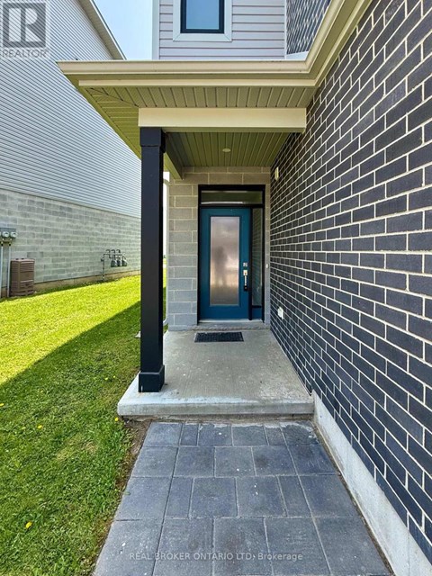 A house entrance with a blue door and a brick wall.