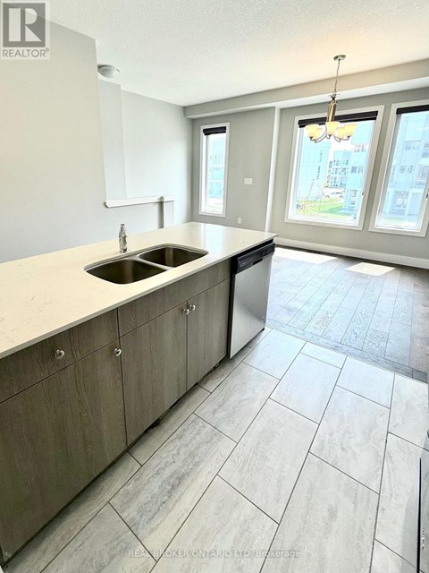 A kitchen with a sink and a window.