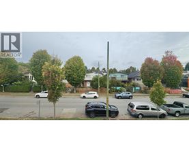 A street view with cars and trees.