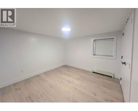 A room with a window and a radiator on the wall.