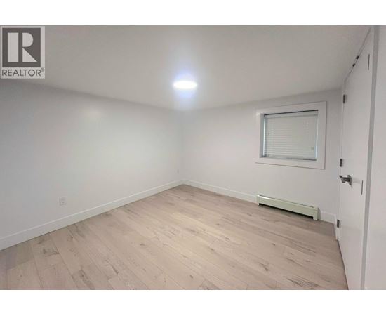 A room with a window and a radiator on the wall.
