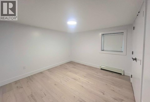 A room with a window and a radiator on the wall.
