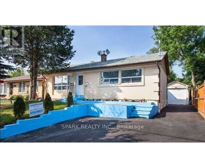 A house with a blue fence in front of it.